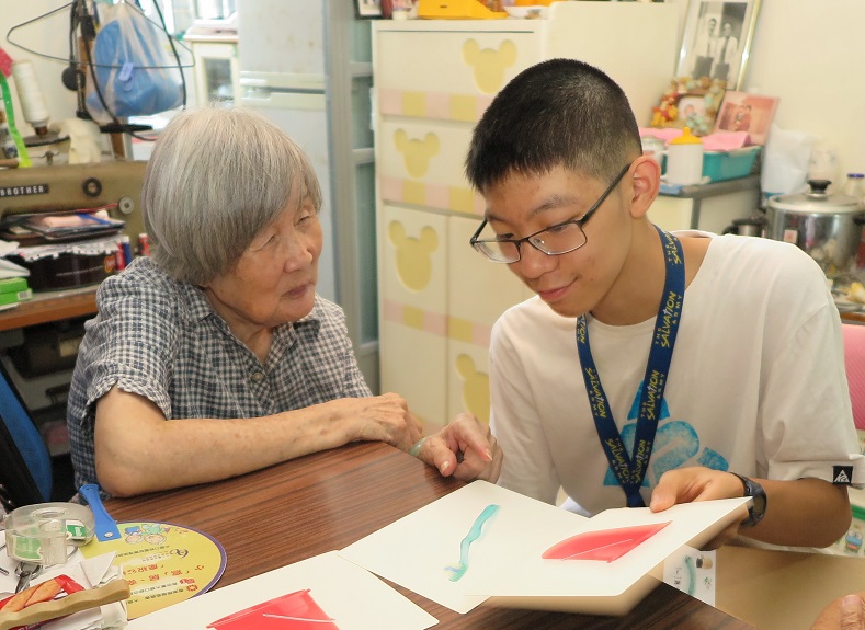 The Salvation Army volunteers regularly visit Madam Choi (left), playing memory games with her to slow down the progression of her illness.